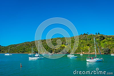 Sailing yachts in Waiheke Island, New Zealand. with a beautiful blue sky and magenta water in a sunny day Stock Photo