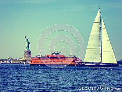 Sailingboat and Staten island ferry boating near Statue of Liberty Editorial Stock Photo
