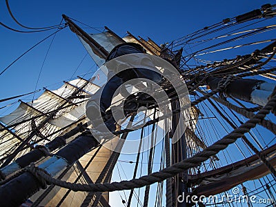 Sailor climbing rigging of traditional tallship or sailboat Stock Photo