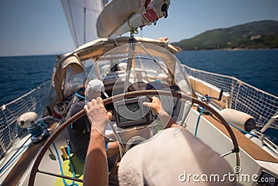 Sailor holding the helm of the sailboat Editorial Stock Photo
