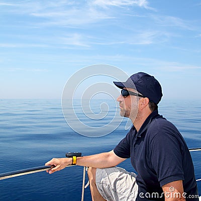 Sailor man sailing boat blue calm ocean water Stock Photo