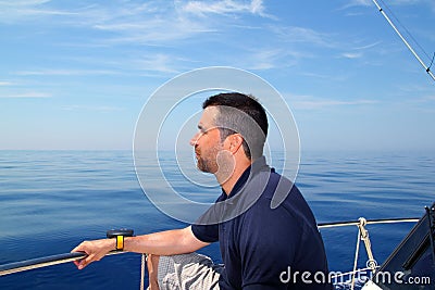 Sailor man sailing boat blue calm ocean water Stock Photo