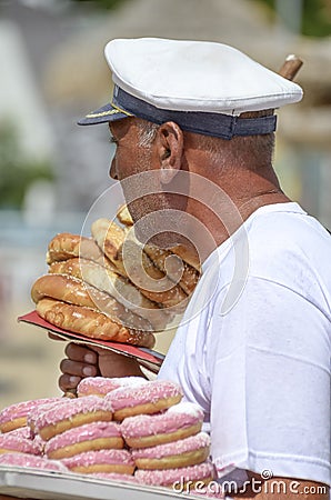 Sailor man hawking food on the beach Editorial Stock Photo