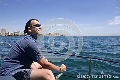 Sailor sailing blue tropical sea on sailboat Stock Photo