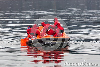 Sailors in an emergency life boat Stock Photo