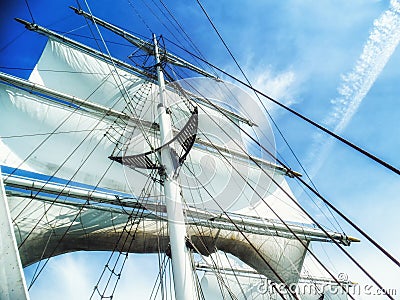 Sails, mast and ropes view from below of a classic sailing ship. Stock Photo