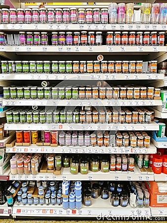 Sainsbury`s supermarket shelves with a huge selection of culinary herbs and spices Editorial Stock Photo