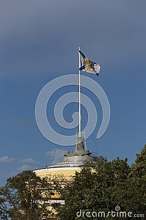 Saint Andrew Andreevsky flag Ensign of the Russian Navy on a flagpole waving the roof of the Admiralty building on a blue sky Stock Photo