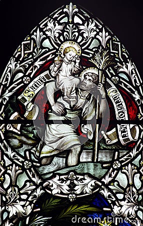 Saint Christopher with baby Jesus on his shoulder (stained glass) Stock Photo