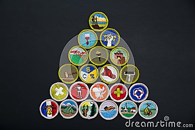 Pyramid of merit badges on black Editorial Stock Photo