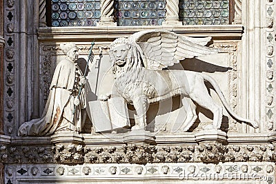 Saint Mark winged lion, white stone statue in sunlight in Venice Stock Photo