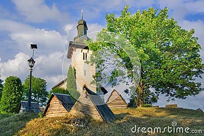 Saint Martin’s Church in Martincek with wooden marquises around during summer sunset Stock Photo