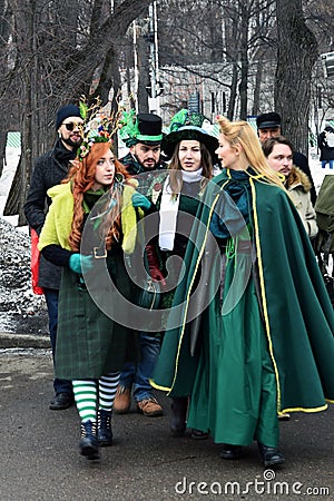 Saint Patrick`s Day celebration in Moscow. Men and women in carnival costumes Editorial Stock Photo