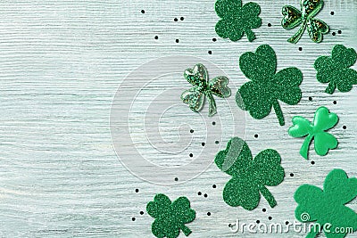 Saint Patricks Day background with green shamrock on white rustic board top view. Stock Photo