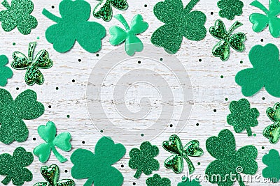 Saint Patricks Day background with green shamrock on white rustic board top view. Stock Photo