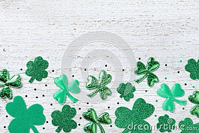 Saint Patricks Day background with green shamrock on white rustic board top view. Stock Photo