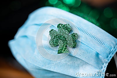 Saint Patricks Shamrock leaf on face mask, concept of Saint patricks festival celebration during coronavirus covid-19 Stock Photo