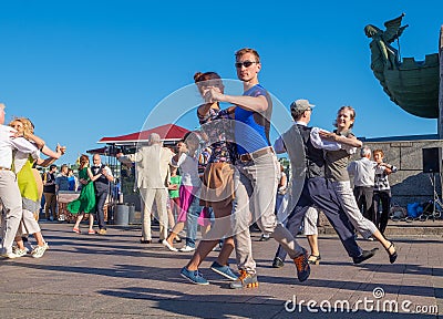 Happy adults are dancing tango or waltz on the city street Editorial Stock Photo