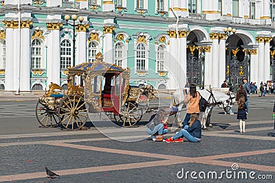 Saint-Petersburg, Russia-August 28, 2021: Young female tourists on the palace square of St. Petersburg are waiting for a ride on a Editorial Stock Photo