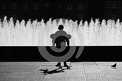 SAINT-PETERSBURG, RUSSIA. Black silhouette of a boy on a skateboard near Complex of singing fountains at Moscow Square Editorial Stock Photo