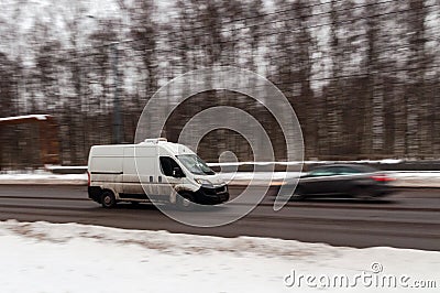 white minibus on a winter road. Motion blur Editorial Stock Photo