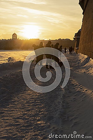 Silhouettes of cadets clearing snow and illuminated by the beautiful evening sun Editorial Stock Photo