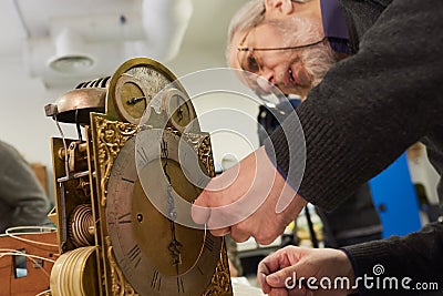 Watch restoration workshop of the state hermitage. Restorer at work repairs gears, watchmaker tools on the table Editorial Stock Photo