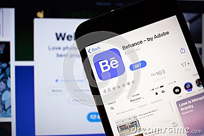 Saint-Petersburg, Russia - 10 January 2020: Mobile phone with Behance by Adobe icon on screen close up with website on laptop, Editorial Stock Photo