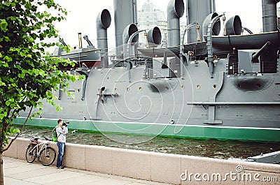 Aurora in St. Petersburg. Tourist photographs the famous ship Editorial Stock Photo