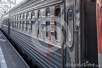 a modern long-distance train arrives on the platform. train car close-up Editorial Stock Photo