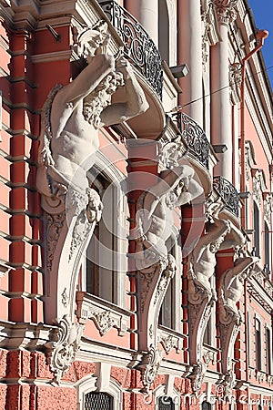 Figures of Atlantes on the facade of the Palace of Beloselsky-Belozersky in St. Petersburg Editorial Stock Photo