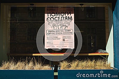 View of an empty storefront with the message help your neighbors Editorial Stock Photo