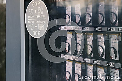 Display case of a vending machine with rows of surgical masks and an indication of the price Editorial Stock Photo