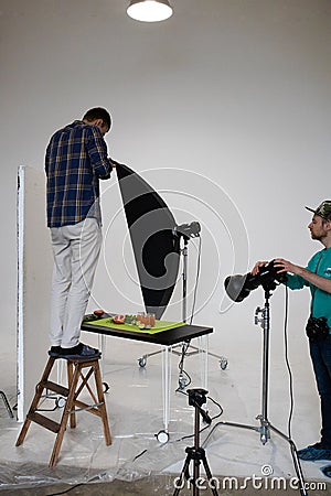 Food photography lesson in a photo studio, a student makes a flat lay Editorial Stock Photo