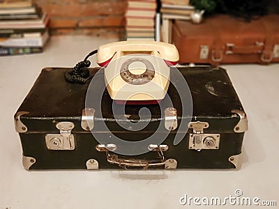 SAINT-PETERSBURG, RUSSIA:Old Soviet suitcase and a beige rotary phone at January 30, 2019 Stock Photo