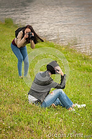 Young woman photographer doing a photoshoot with model outdoors Editorial Stock Photo