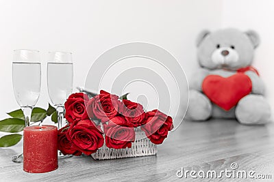 Saint Valentine`s day bouquet of roses, candle and teddybear Stock Photo
