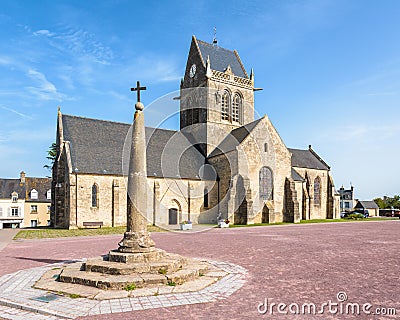 Notre-Dame-de-l'Assomption church and calvary in Sainte-Mere-Eglise, Normandy Editorial Stock Photo