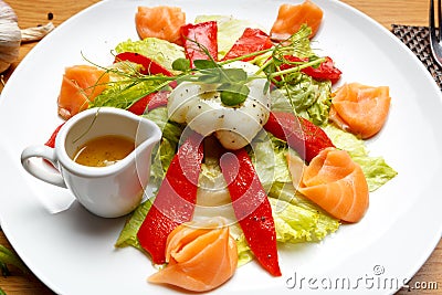 Salad with baked pepper, salmon and poached egg Stock Photo