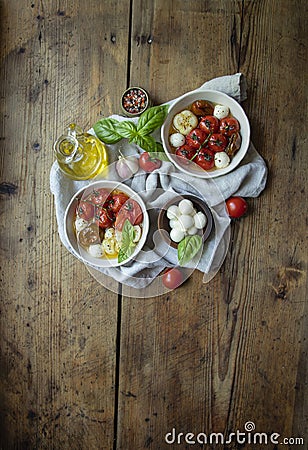 Salad. Baked tomato, basil, garlic with mozzarella cheese, ceramic dishes. cooking, cooked dish Stock Photo