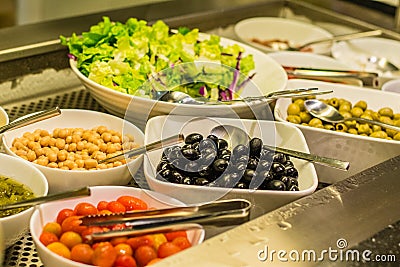 Salad bar with vegetables, chickpeas, rice, olives Stock Photo