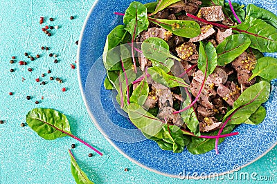 Salad of chicken liver and leaves of spinach and chard. Flat lay Stock Photo