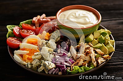 Salad cobb- avocado, tomatoes, bacon, chicken and onion. Stock Photo