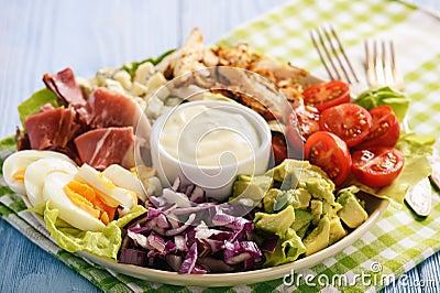 Salad cobb- avocado, tomatoes, bacon, chicken and onion. Stock Photo