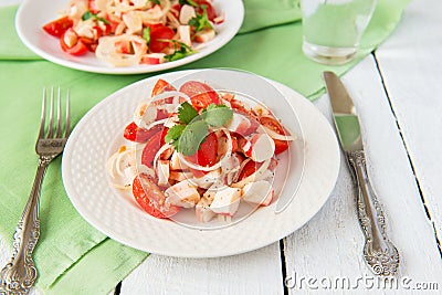 Salad from crabmeat sticks and tomatoes Stock Photo