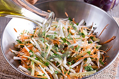 Salad of fresh vegetables. Vegetarian ingredient and olive oil for cooking healthy meal. Sliced white cabbage, paprika, cucumber, Stock Photo