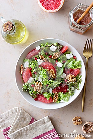 Salad with grapefruit, white cheese, pomegranate and nuts. Healthy eating. Vegetarian food. Diet Stock Photo