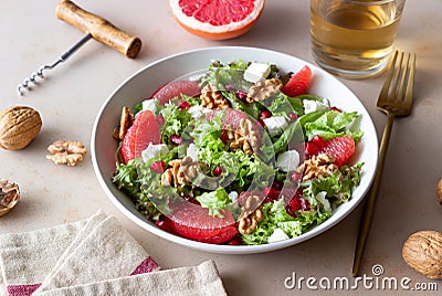Salad with grapefruit, white cheese, pomegranate and nuts. Healthy eating. Vegetarian food. Diet Stock Photo