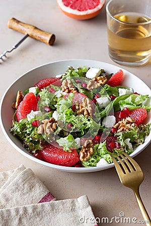 Salad with grapefruit, white cheese, pomegranate and nuts. Healthy eating. Vegetarian food. Diet Stock Photo