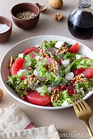 Salad with grapefruit, white cheese, pomegranate and nuts. Healthy eating. Vegetarian food. Diet Stock Photo